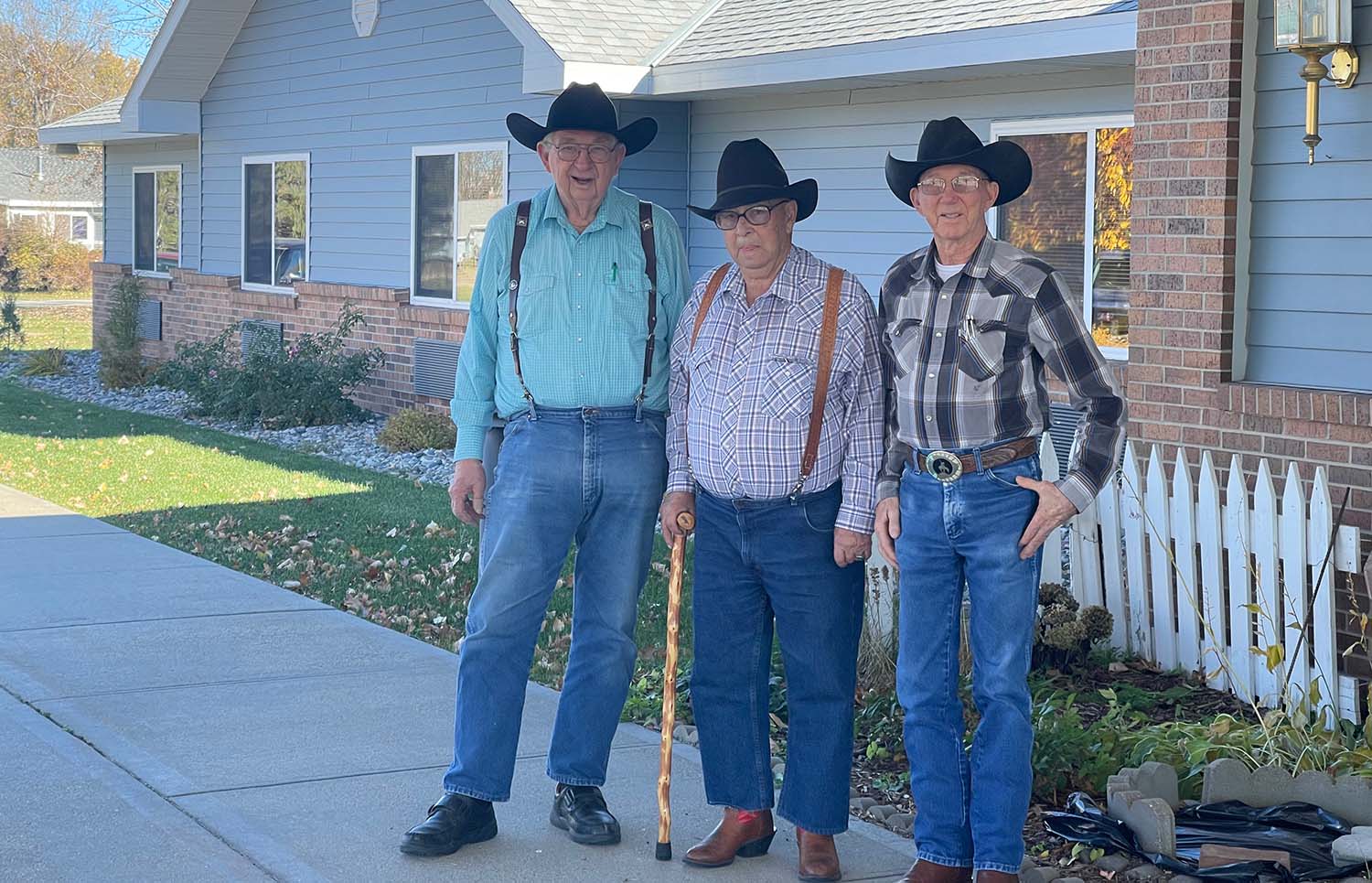 three residents , each wearting coyboy hats